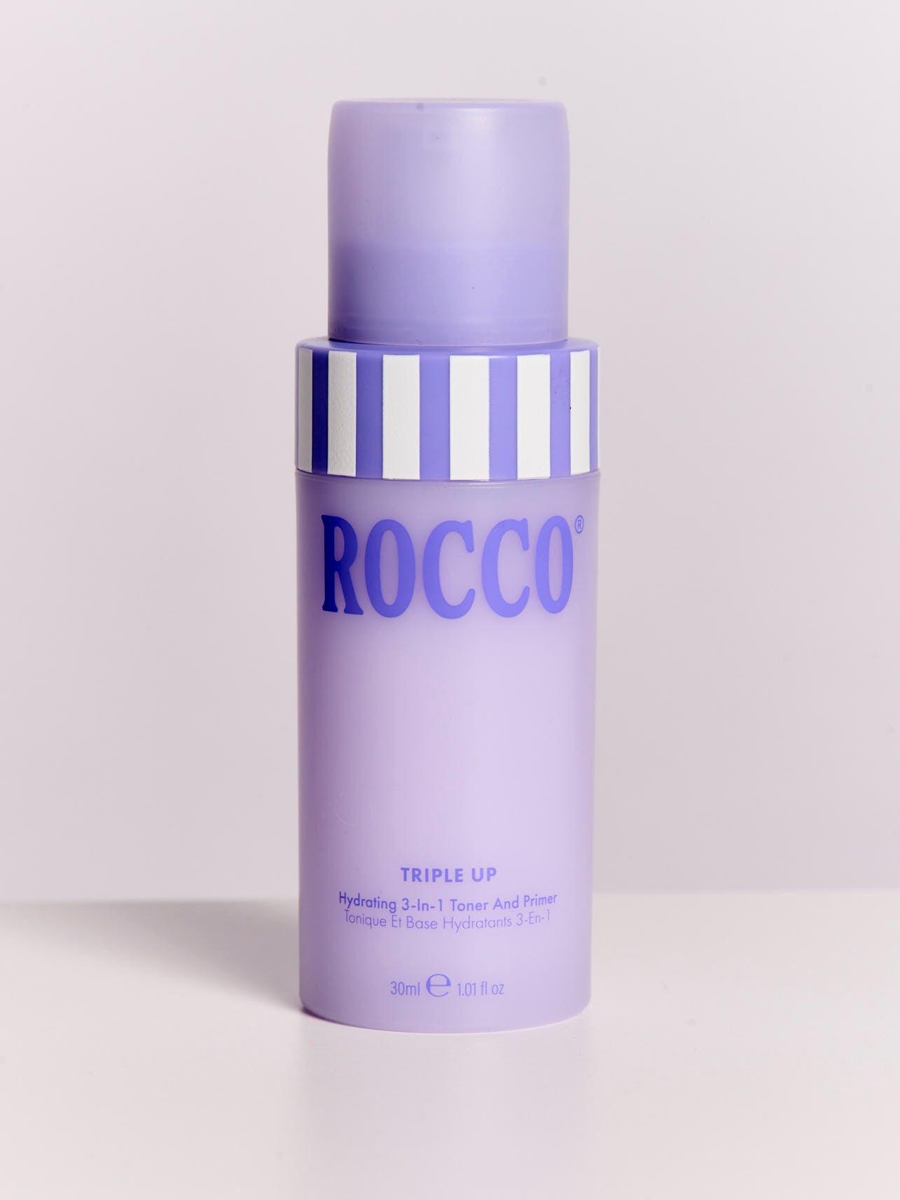 Purple bottle of Rocco Triple Up Hydrating 3-in-1 Toner and Primer on a white background