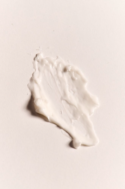 White cream or lotion on a beige background