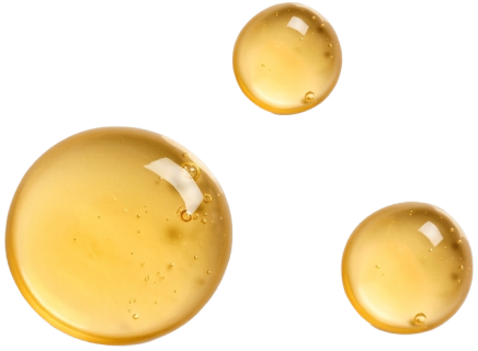 Three droplets of yellow Baobab liquid on a white background